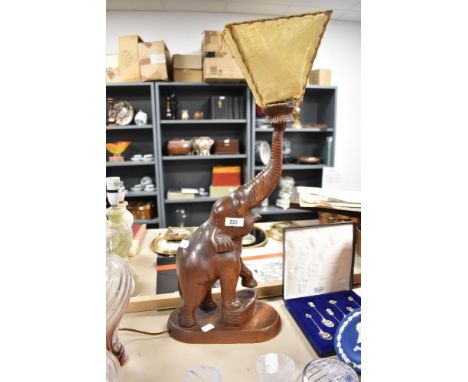 An early 20th century figural lamp of an Indian Elephant carved in hard wood.