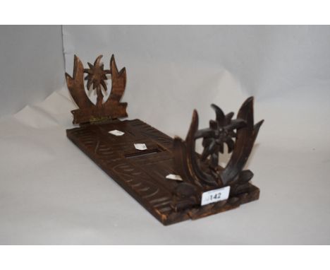 A vintage softwood slide fold out book shelf wooden carved with decorated ends.