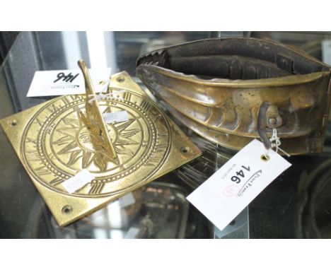 Small brass sundial with engraved decoration and a Repousse brass hinged tapering leaf shaped clip. Stamped 'Patent', suggest
