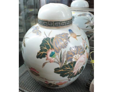 Pair of oriental porcelain enamel decorated baluster shaped ginger jars and covers, overall decorated with herons amongst fol