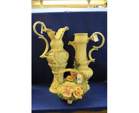 Two similar large Italian pottery ewers and a similar floral decorated baluster shaped teapot. (3)