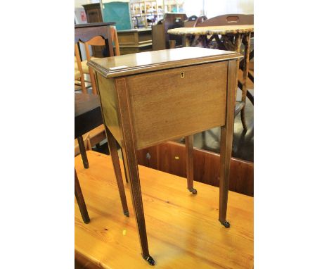 Edwardian strung inlaid mahogany ladies' sewing box on square tapering legs with ceramic casters. Fitted interior. 