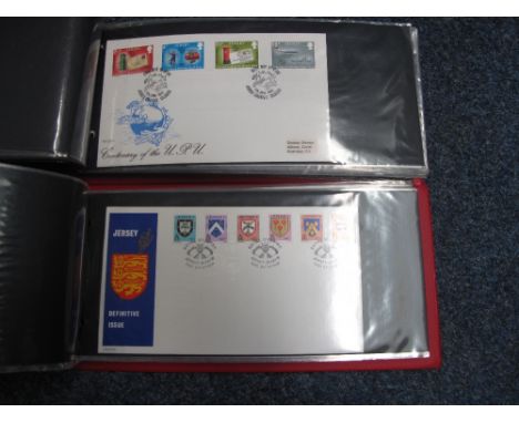 Jersey selection of First Day Covers and few booklets and presentation packs in 2 red albums.