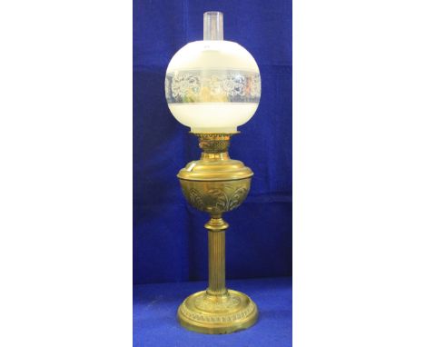 Early 20th century brass double burner oil lamp with Repousse brass reservoir on fluted column with circular Repousse base. E