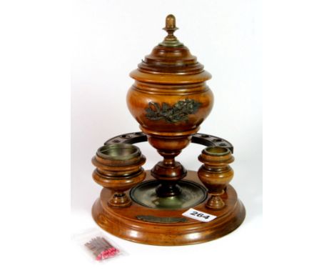 An early 20th century walnut pipe smokers stand, H. 25cm.