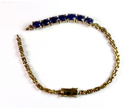 A 14ct yellow gold bracelet (stamped 585) and set with seven sapphires, approx. 9.6g. Please note this lot is a credit card r