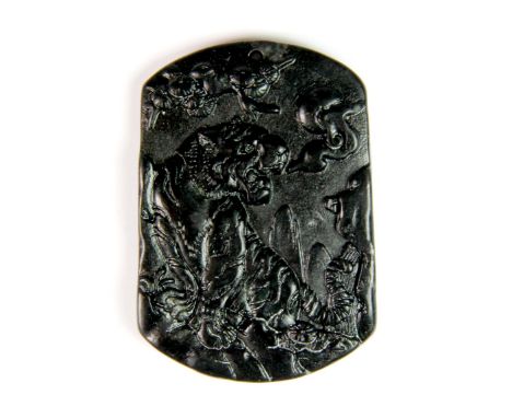 A beautifully carved Chinese dark green jade tiger amulet, 5.1 x 3.5cm.