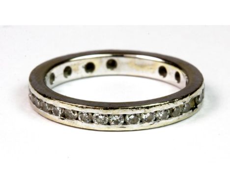 A white metal (tested min 9ct gold) diamond set eternity ring. (J), approx. 2.6g.  Please note this lot is a credit card recl