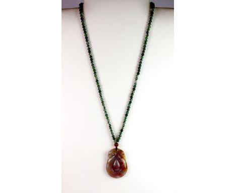 An unusual mixed colour Chinese double headed jade dragon amulet on a spinich jade bead necklace.