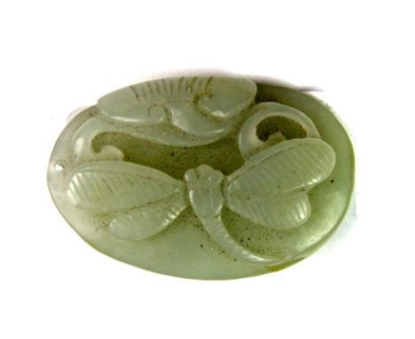 A small Chinese carved pebble jade amulet of a dragonfly and lotus, H. 4cm.