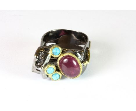 A white metal (tested silver) and gilt industrial modernist square ring set with turquoise and a large ruby, by Hana Maae.