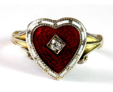 An antique 18ct gold (stamped 18ct) and enamel heart shaped ring set with a diamond. N.