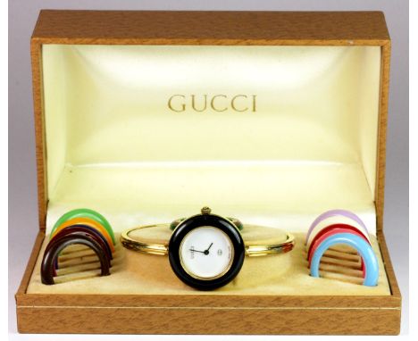 Gucci lady's bangle wristwatch with multiple bezels in original leather box.
