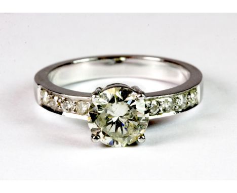 A 14ct white gold (stamped 585) diamond solitaire ring (approx 1.5ct) with diamond set shoulders (P), approx 4.6g. Please not