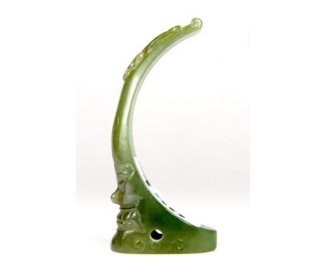 An unusual old Chinese celadon jade Mandarin hair decoration featuring a guardian face and a dragon, H. 9cm.