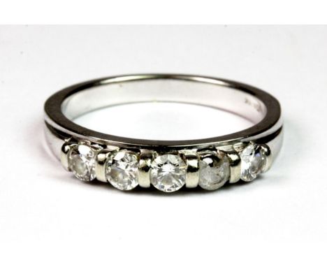 An 18ct white gold (stamped 18ct) five stone diamond ring. (M), approx. 3.4g, 1 diamond broken.  Please note this lot is a cr