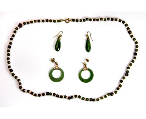 A jade and coral necklace and two pairs of jade earrings.