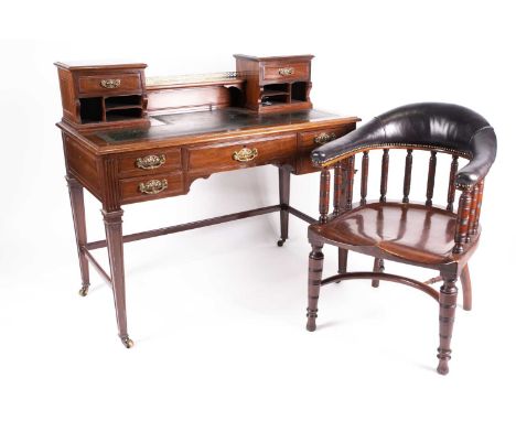 An Edwardian mahogany Bonheur du Jour with small drawers and pigeon holes above a leathered top, the base with a single friez
