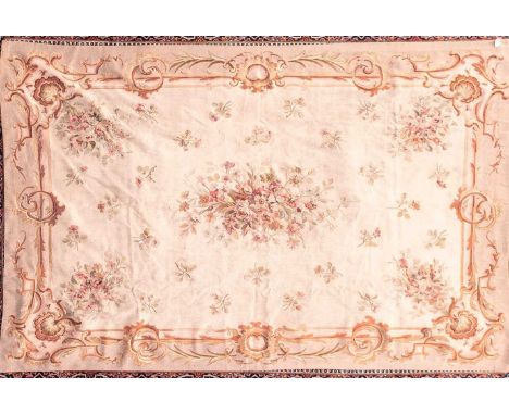 A 20th century ivory ground Aubusson style tapestry carpet with a central spray of roses within a scroll border. 287 cm x 185