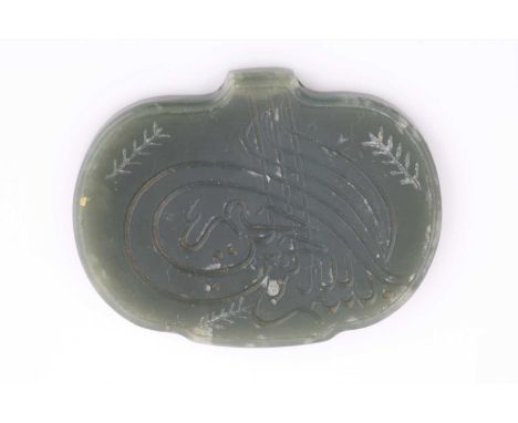 An Indo Persian bean shape jade pendant, engraved with a single calligraphic character, 4.9cm.