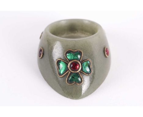 An Indian moss green jade archer's ring yellow metal set with cabochon hardstone flowers and boss motif. 4.6 cm x 3.3 cm