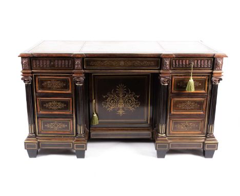 A 19th century French Empire brass inlaid ebonized and mahogany inverted breakfront bureau kneehole desk, with leathered top 
