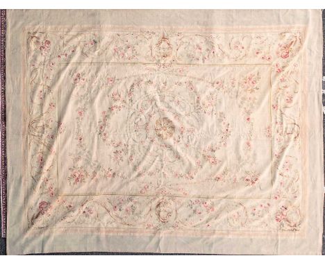 A 20th-century ivory ground Aubusson style tapestry carpet with central floral motif and within neo-classical borders. 356 cm