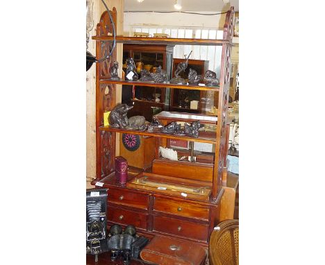 Mahogany four-tier wall shelf with pierced ends and four small drawers