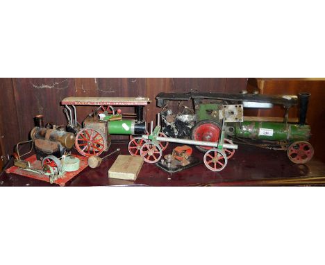 Old scratch built steam traction engine model, a Mamod Steam Tractor, with logs trailer and a similar stationary steam beam e