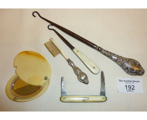 Button hooks, one with silver handle, small silver-handled brush, fruit knife and a celluloid pocket or purse mirror