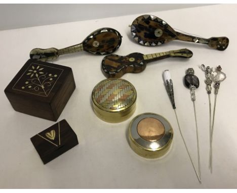 A small lot of mixed items. Comprising:- 2 tri-colour metal pill boxes, 2 wooden trinket boxes inlaid with brass, 4 hat pins,