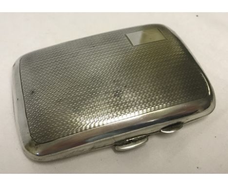 A small hallmarked silver cigarette case with engine turned detail and blank rectangular cartouche.  Approx. 6.5cm x 8cm. Ple