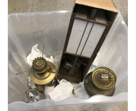 A box of lamps. Comprising 2 brass base oil lamps, a glass base oil lamp, 2 glass chimneys and a boxed wooden oriental style 