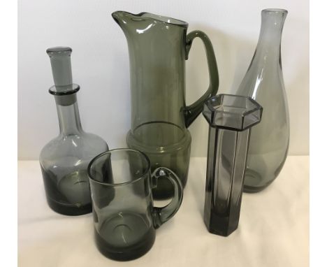 A collection of smoked glass pieces to include a Dartington Glass decanter.  Please Note: All enquiries will be responded to 