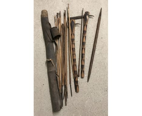 A leather spear and arrow case with contents together with 2 wooden handled tomahawks.  Please Note: All enquiries will be re