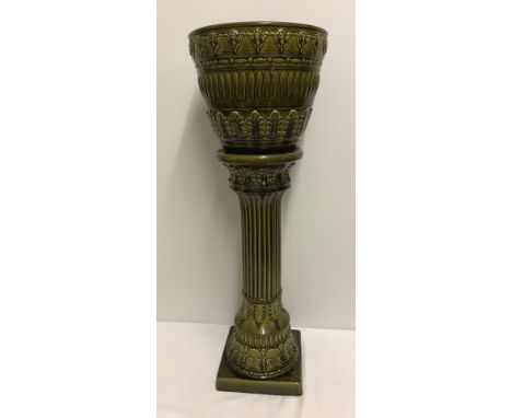 An olive green ceramic jardinere and stand.  Please Note: All enquiries will be responded to after we re-open in the new year