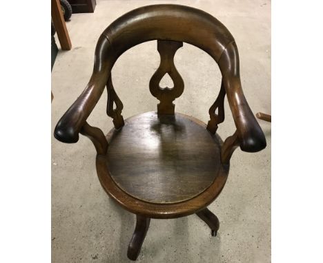 An oak 4 footed swivel captains chair with ceramic castors.  Please Note: All enquiries will be responded to after we re-open