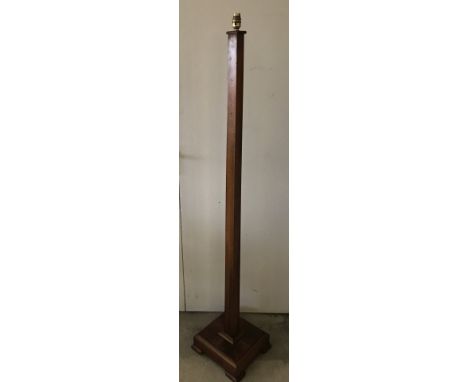 A Walnut Art Deco style standard lamp with brass bulb fixing.  Total height 158cm approx. Please Note: All enquiries will be 