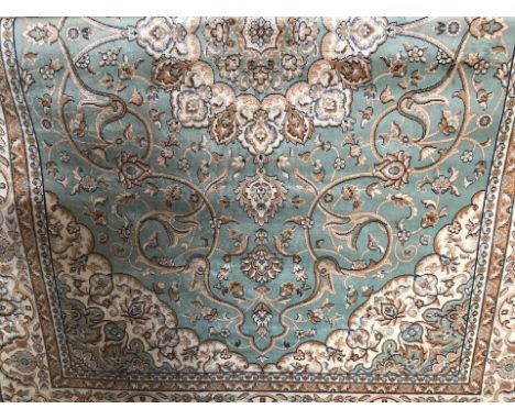 A new Keshan carpet with pale green coloured background. With gold and beige colouring. Approx. 230cm x 160cm. Please Note: A