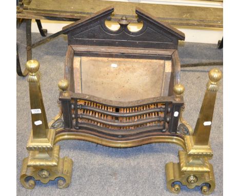 A brass and cast iron fire insert in the architectural taste 