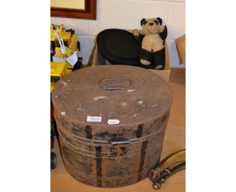 A metal hat box, two top hats, puppet and a teddy bear 