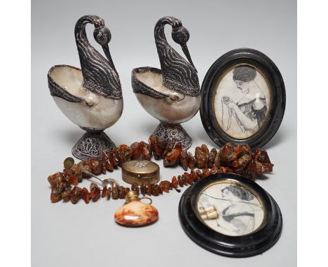 A pair of mother of pearl and silvered swan ornaments, amber and mixed collectables