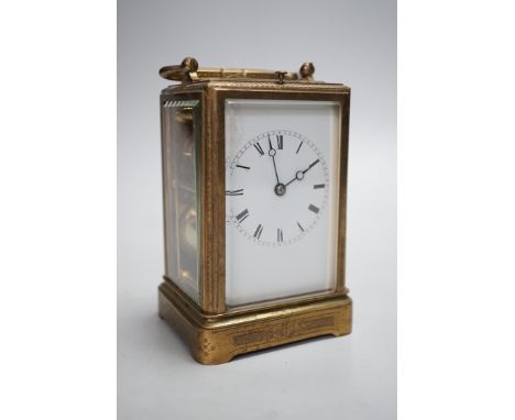 A 19th century French chased gilt brass cased carriage clock with black Roman dials and second spacers over a white dial, ins