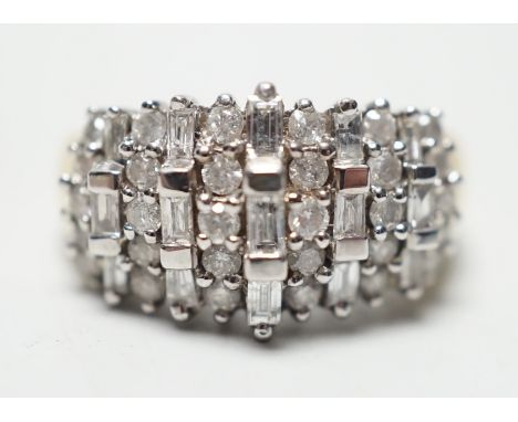 A modern yellow metal, round and baguette cut diamond set half hoop cluster ring, size L/M, gross weight 5.6 grams.