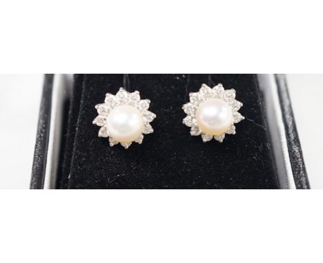 A modern pair of 18ct white gold, cultured pearl and diamond cluster set ear studs, 11mm, gross weight 3 grams.