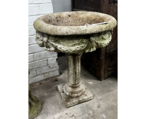 A reconstituted stone circular garden planter, width 49cm, height 65cm