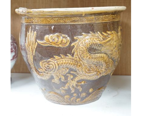 A Chinese Brown and treacle glazed dragon planter. 32cm tall