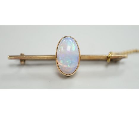 A yellow metal and single stone oval white opal set bar brooch, 39mm, gross weight 4.3 grams.