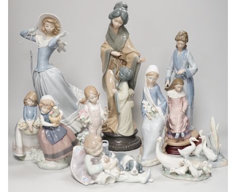 Seven Lladro and two Nao porcelain figures together with another, stuck to base so mark can’t be seen. Tallest 38cm