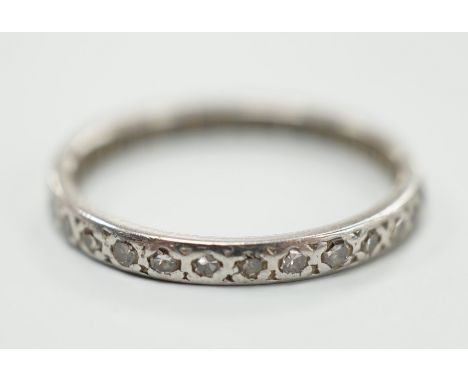 A white metal and diamond chip set full eternity ring, size K, gross weight 1.8 grams.